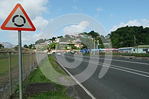 A main road with traffic sign roundabout passing through the Caribbean island of Saint Lucia, near Castries Harbour. photo