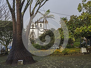 Main square with park and church Igreja de Sao Miguel Arcanjo in the center of Vila Franca do Campo town, located on Sao photo