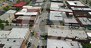 Main street intersection with slow traffic and old historical architecture in small town America. Flat roof southern