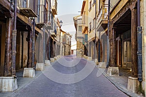 Main street with medieval arcades made of wooden columns in San Estaban de Gormaz, Soria. photo