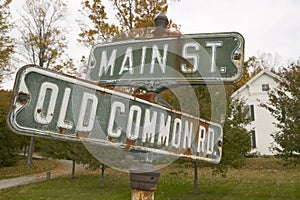 Main Street USA and Old Common Road sign in autumn, western Massachusetts, New England