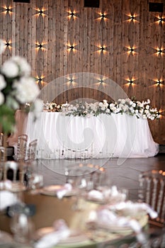 Main table at a wedding reception with beautiful fresh flowers. Wedding day.