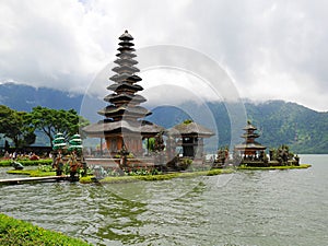 Main temple on the water in Bali, Pura Oolong Danu Bratan, Lake Bratan, beautiful temple, water around the temple, statues in Bali