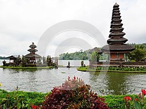 Main temple on the water in Bali, Pura Oolong Danu Bratan, Lake Bratan, beautiful temple, water around the temple, statues in Bali