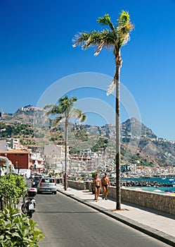 The main tourist promenade of Giardini Naxos on the island of Sicily Italy