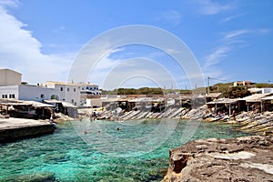 Main view of Es Calo fishermen bay, with white village houses on background, Formentera, Balearic Islands, Spain