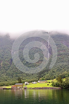 Main view of Styvi village and its farm museum with surrounding waterfalls on background.