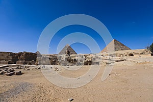 Main View to the Great Sphinx of Giza, is a giant limestone statue with the Great Pyramid in Background in Giza