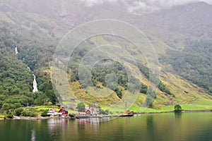 Main view of Tuftofossen waterfall and Tufto farm in Norway.