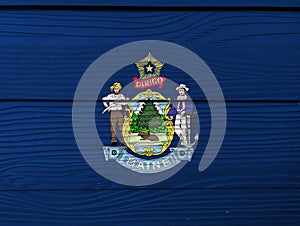 Maine flag color painted on Fiber cement sheet wall background. Maine coat of arms defacing blue field
