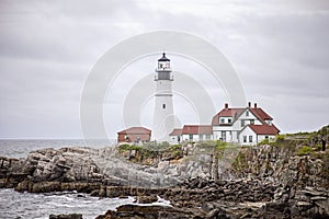 Maine lighthouse Portland Head Light and rocky cliff