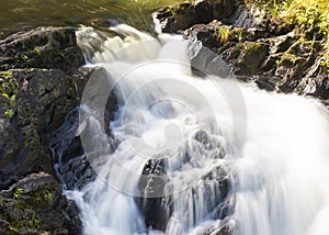 Maine stream running over the rocks in a cascade