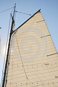 Mainsail and Wooden Mast of Schooner Sailboat photo