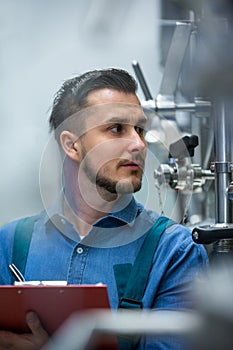 Maintaince worker wrting on clipboard