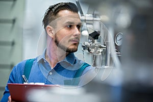 Maintaince worker wrting on clipboard
