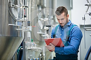 Maintaince worker wrting on clipboard