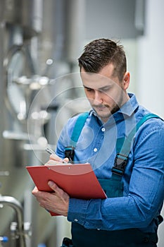 Maintaince worker wrting on clipboard