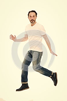 Maintaining active lifestyle. Active man jump isolated on white. Middle age adult. Mature person in casual style