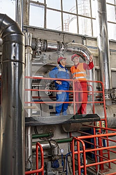 Maintenance Engineer Standing Next to Oil Worker in Oil Refinery