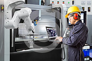 Maintenance engineer use laptop computer control automatic robot