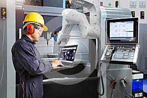 Maintenance engineer using laptop computer control automatic rob