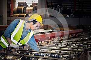 maintenance engineer working in industrial plant, he is repairing machines to be used at full efficiency