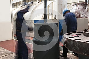 Maintenance engineers checking technical data of heating system equipment