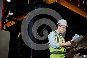 Maintenance engineers men and women inspect relay protection system with checklist document . They work a heavy industry