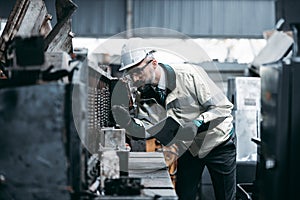 The Maintenance looking of working at industrial machinery