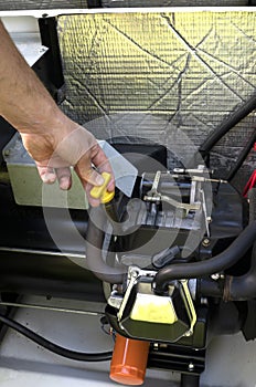 Maintenance. Mechanic Inspecting the generator. Man checking engine in generator, measuring oil level.