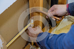 Maintenance plumber service home bathroom in repair of plastic polypropylene water pipes in hole wall