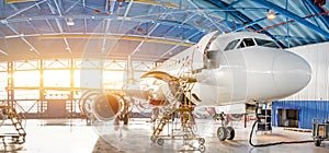Maintenance and repair of aircraft in the aviation hangar of the airport, view of a wide panorama photo