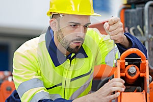 Maintenance service engineer working with mechanical machine
