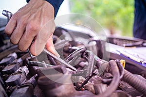 The maintenance technician is checking the condition of the engine to be ready for use. In the car service center