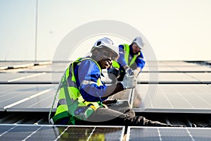 Maintenance technicians installing solar panels at solar cell farm