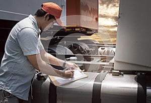 Maintenance and Vehicle safety inspection. Asian a truck driver inspecting fuel tank of semi truck.