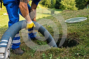 Maintenance Worker emptying household septic tank