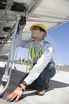 Maintenance Worker Installing Solar Photovoltaic Panels