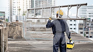 Maintenance worker man carrying aluminium ladder