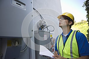 Maintenance Worker Reading Meter Of Solar Generation