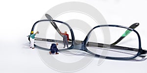 Maintenance workers on a spectacle frame with yellow glasses