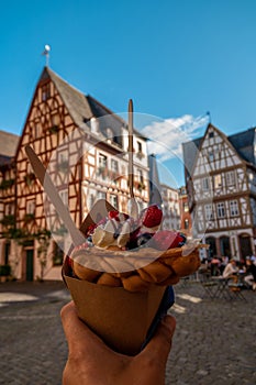 Mainz Germany hand with ice cream , Classical timber houses in the center of Mainz, Germany