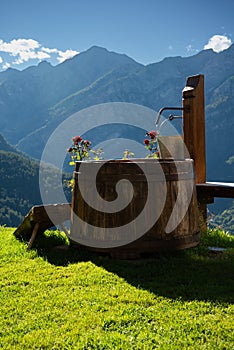 Wooden water fountain in the Italian Alps, Piemonte, Italy