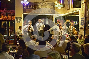 Maison Bourbon Jazz Club with Dixieland band and trumpet player performing at night in French Quarter in New Orleans, Louisiana