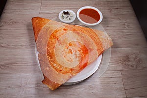 Maisoor dosa is a South Indian dish that is served with sambhar and coconut rubble. Selective focus