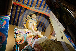 Maitreya buddha statue in Namgyal Tsemo Monastery with windowlight.Monastery is too dark Inside.