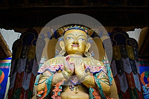 Maitreya buddha statue in Namgyal Tsemo Monastery with windowlight.Monastery is too dark Inside.