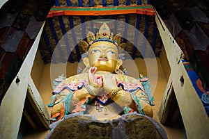 Maitreya buddha statue in Namgyal Tsemo Monastery with windowlight.Monastery is too dark Inside.