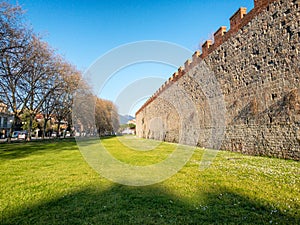 Majestic ancient medieval walls of Pisa with gardens, Tuscany -