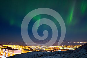 Majestic arctic landscape with aurora borealis over the northern city of Anadyr